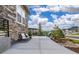 Side view of the home showcasing stone accents, a patio with seating, and professional landscaping at 4213 Hickory Oaks St, Castle Rock, CO 80104