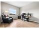 Bright home office featuring hardwood floors, a large window, modern desk setup, and a comfortable black recliner at 4213 Hickory Oaks St, Castle Rock, CO 80104