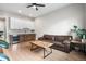 Living room with hard wood floors, brown leather couch, and white cabinets with mini-fridge at 4213 Hickory Oaks St, Castle Rock, CO 80104