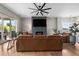 Open living room with hardwood floors, a modern fireplace, a large TV, comfortable seating and access to the patio at 4213 Hickory Oaks St, Castle Rock, CO 80104