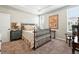 Bedroom features carpet, iron bed frame, vintage decor, neutral walls, and a large poster at 5417 Riverbend Ave, Firestone, CO 80504