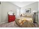Charming bedroom features a bed, red dresser, and decor creating a cozy retreat at 5417 Riverbend Ave, Firestone, CO 80504