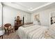 Bedroom with decorative iron bed frame, vintage side table, carpeted floors, and chair at 5417 Riverbend Ave, Firestone, CO 80504