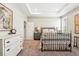 Well-lit bedroom showcases neutral tones, carpet, iron bed frame, and classic decor touches at 5417 Riverbend Ave, Firestone, CO 80504