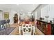 Spacious dining area featuring hardwood floors, neutral paint, and backyard access at 5417 Riverbend Ave, Firestone, CO 80504