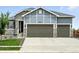 Charming two-story home with a three-car garage, stone accents, and a well-maintained front yard at 5417 Riverbend Ave, Firestone, CO 80504