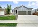Beautiful home with a spacious driveway leading to a three-car garage and a landscaped front yard at 5417 Riverbend Ave, Firestone, CO 80504