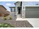 Close-up of the front entrance showing stone accents and mature shrubs at 5417 Riverbend Ave, Firestone, CO 80504