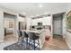 Bright kitchen has island seating with modern cabinets and appliances and a stylish rug at 5417 Riverbend Ave, Firestone, CO 80504