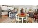 Open-concept kitchen flows into living room with a dining table and island seating at 5417 Riverbend Ave, Firestone, CO 80504
