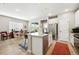 Kitchen island features bar stool seating with stainless steel appliances and modern sink at 5417 Riverbend Ave, Firestone, CO 80504