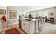 Open floor plan with kitchen island with stainless steel dishwasher, dining table, and living room at 5417 Riverbend Ave, Firestone, CO 80504