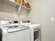 Convenient laundry room featuring modern, white washer and dryer units for easy chores at 5417 Riverbend Ave, Firestone, CO 80504