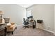 Home office setup featuring desk, printer, chair, and a comfortable armchair at 5417 Riverbend Ave, Firestone, CO 80504