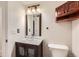 This bathroom has a modern vanity, an overhead cabinet, and a decorative mirror at 740 N Sherman St # 107, Denver, CO 80203