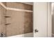 Shower/tub combo with tiled walls and built in shelves. White trim and door at 740 N Sherman St # 107, Denver, CO 80203
