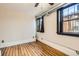 Bedroom featuring hardwood floors, a ceiling fan, and windows with dark trim at 740 N Sherman St # 107, Denver, CO 80203