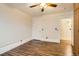 A bright bedroom with hardwood floors, white walls and trim, a ceiling fan, and ample natural light at 740 N Sherman St # 107, Denver, CO 80203