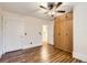 A well-lit bedroom with hardwood floors and built-in storage, ceiling fan and white trim at 740 N Sherman St # 107, Denver, CO 80203