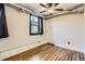 Bedroom featuring hardwood floors, a ceiling fan, and a window with curtains at 740 N Sherman St # 107, Denver, CO 80203