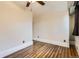 This bedroom has hardwood floors, a ceiling fan, and a window with dark trim at 740 N Sherman St # 107, Denver, CO 80203