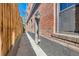 The building's exterior features a brick facade and a narrow walkway, under bright skies at 740 N Sherman St # 107, Denver, CO 80203