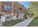 Brick apartment building with stone stairway and landscaping along a sidewalk at 740 N Sherman St # 107, Denver, CO 80203