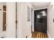 Hallway featuring hardwood floors, white walls, and access to the bathroom at 740 N Sherman St # 107, Denver, CO 80203