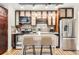 Modern kitchen with stainless steel appliances, island, and hardwood floors at 740 N Sherman St # 107, Denver, CO 80203