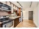 Modern kitchen with stainless steel appliances and hardwood floors at 740 N Sherman St # 107, Denver, CO 80203