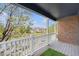 Outdoor balcony showcasing a neighborhood view, a brick wall, and a white railing at 3542 W 125Th Dr, Broomfield, CO 80020