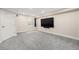 Finished basement featuring neutral paint, plush carpeting, a window, and a large TV at 3542 W 125Th Dr, Broomfield, CO 80020