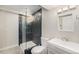 Bathroom with a modern glass shower featuring unique tiling, a toilet, and a sink with a vanity at 3542 W 125Th Dr, Broomfield, CO 80020
