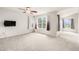 Spacious bedroom with a ceiling fan, two windows with vibrant curtains, and neutral carpeting at 3542 W 125Th Dr, Broomfield, CO 80020