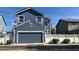 Two-story home with blue siding, a gray garage door, and white picket fence in the front yard at 3542 W 125Th Dr, Broomfield, CO 80020