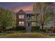 Charming two-story brick home with a lovely front porch viewed at dusk at 3542 W 125Th Dr, Broomfield, CO 80020