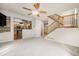 Open-concept living room featuring a staircase and seamless flow to the adjacent kitchen at 3542 W 125Th Dr, Broomfield, CO 80020