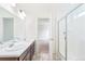 Bright bathroom features a double vanity and a glass-enclosed shower at 20630 E 58Th Ave, Aurora, CO 80019