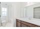 Bright bathroom features a vanity with a single sink and tub with shower at 20630 E 58Th Ave, Aurora, CO 80019