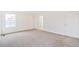 Spacious bedroom with neutral carpet and an adjacent bathroom at 20630 E 58Th Ave, Aurora, CO 80019