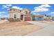 Two-story home with tan and red exterior colors and a two-car garage situated on a spacious lot at 20630 E 58Th Ave, Aurora, CO 80019