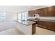 Open concept kitchen featuring an island with a sink, stainless steel appliances, and granite countertops at 20630 E 58Th Ave, Aurora, CO 80019