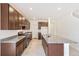 Kitchen featuring an island with a sink, granite countertops, and stainless steel appliances at 20630 E 58Th Ave, Aurora, CO 80019