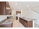 Open concept kitchen featuring a center island with a sink, granite countertops, and stainless steel appliances at 20630 E 58Th Ave, Aurora, CO 80019