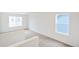 Bright living room featuring neutral walls, plush carpeting, and large windows with views at 20630 E 58Th Ave, Aurora, CO 80019