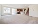 Open-concept living space with new carpet, a modern kitchen, and a staircase, creating an inviting atmosphere at 20630 E 58Th Ave, Aurora, CO 80019