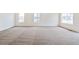 Bright living area with neutral decor, plush carpeting, and large windows, offering plenty of natural light at 20630 E 58Th Ave, Aurora, CO 80019