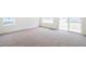 Spacious living room with soft carpeting and sliding glass doors, creating a comfortable and inviting atmosphere at 20630 E 58Th Ave, Aurora, CO 80019