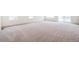 Open living space featuring neutral carpeting and abundant natural light streaming through large windows at 20630 E 58Th Ave, Aurora, CO 80019