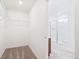 Walk-in closet leads to a bright bathroom with a glass-enclosed shower at 20630 E 58Th Ave, Aurora, CO 80019